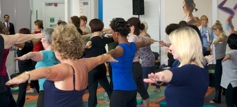 Students preparing for uttitha trikonasana Yoga Show